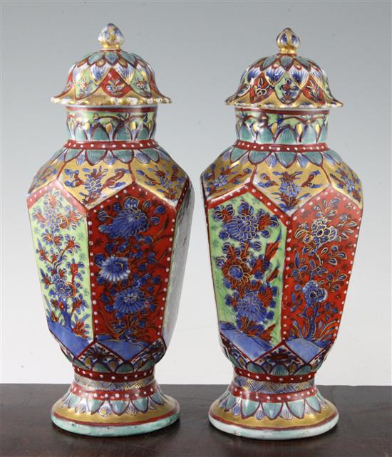 A pair of Chinese hexagonal baluster clobbered vases and covers, 18th century and later, 31.5cm